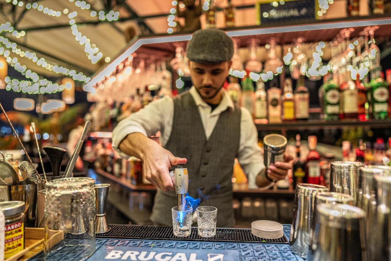 Hotel Lobby Sevilla Bagian luar foto A bartender at work