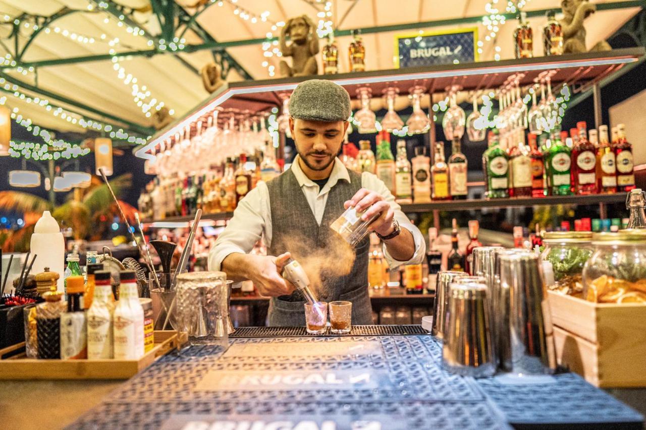 Hotel Lobby Sevilla Bagian luar foto A bartender at work
